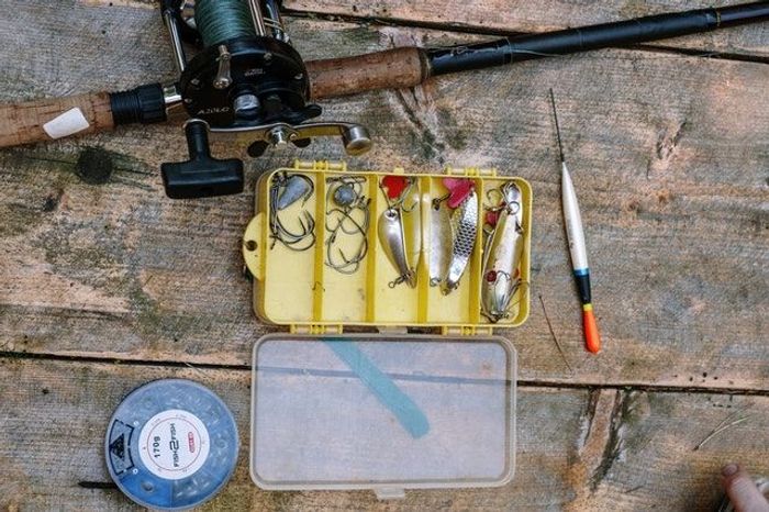 Fishing tackle laid out on a wooden floor outdoor