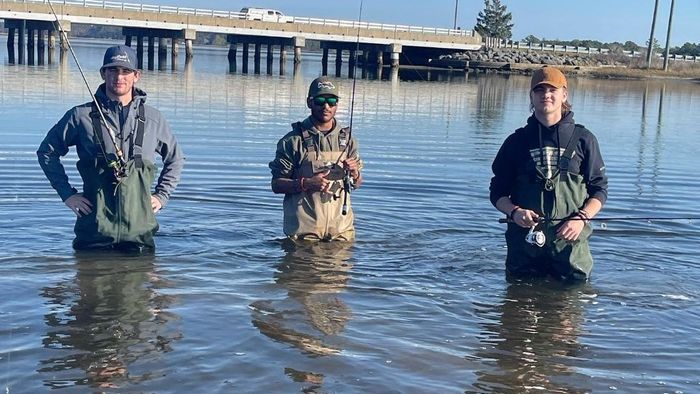 anglers with their fishing gears dipped in water