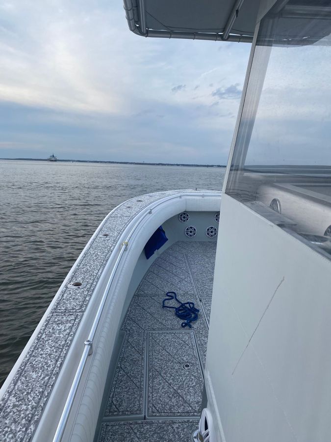 white charter boat sailing across the water body