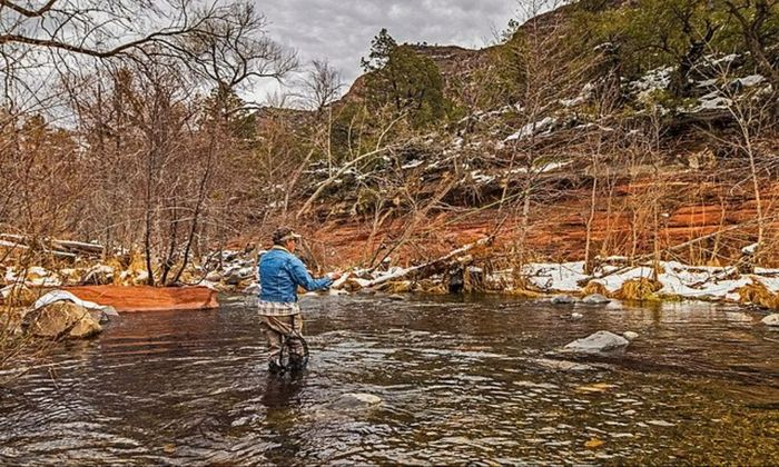 man fly fishing during winter 