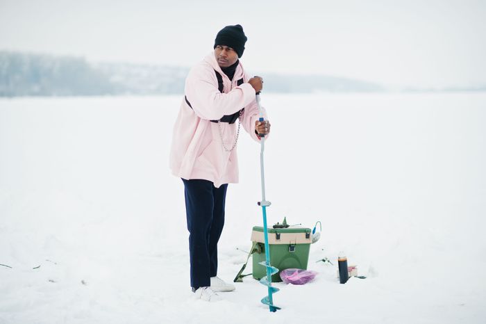 african-american-fisherman-making-hole-frozen-ice-by-drill-winter-fishing.jpg