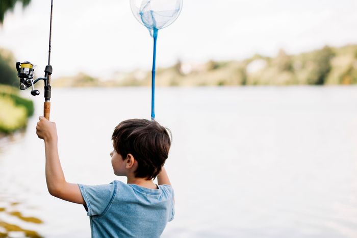boy-holding-fishing-rod-net-near-lake.jpg