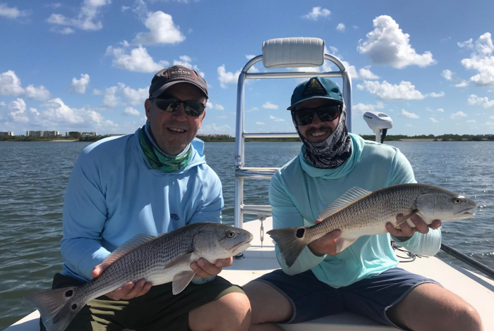 anglers holding fish