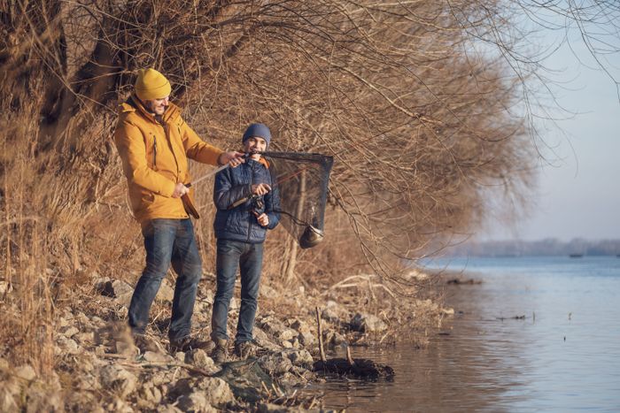 father-son-are-fishing-sunny-winter-day-they-caught-fish.jpg