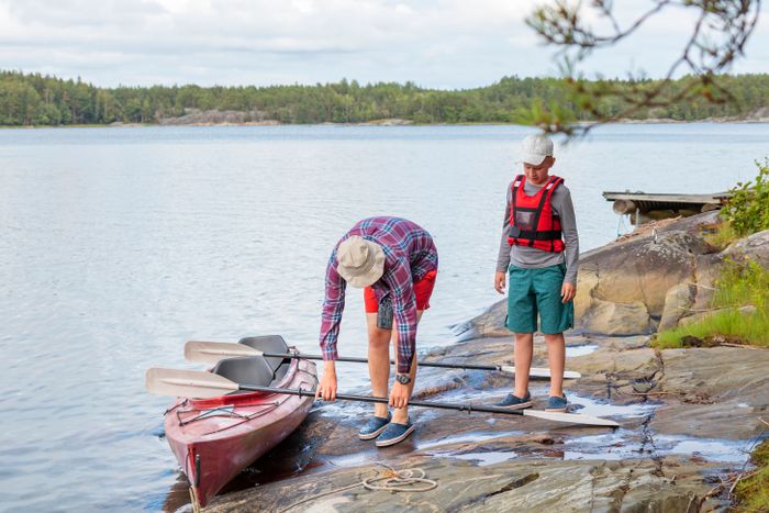 father-son-are-preparing-kayaking-by-sea-canoeing-boating-baltic-sea-family-summer-vacations-finland.jpg