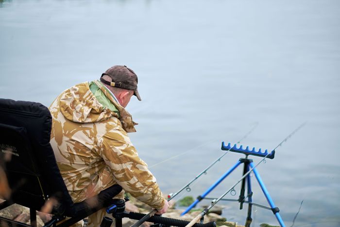 fisherman-waiting-bite-holds-fishing-rod-cutting-fish-bite.jpg