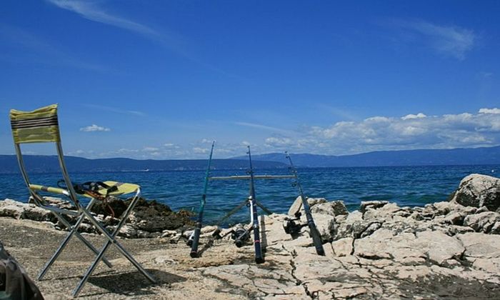 chair, fishing rods, sea, rocks