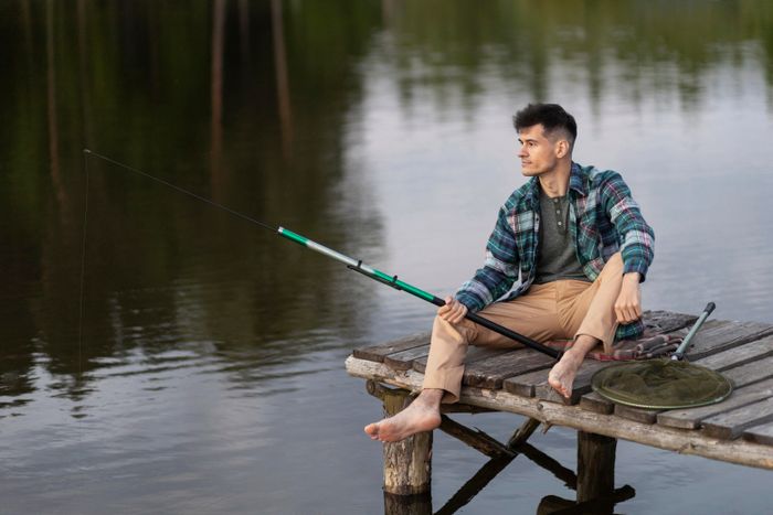 full-shot-smiley-man-fishing.jpg