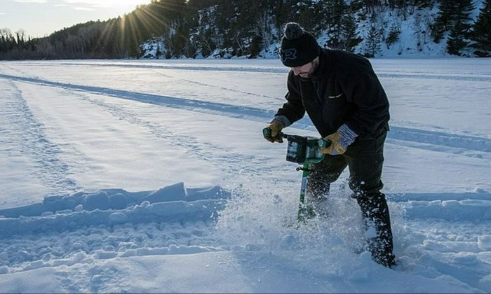 man drilling ice, ice fishing