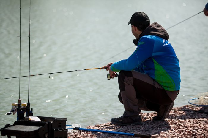 kyiv-ukraine-april-16-2018-caucasian-fisherman-catches-fish-with-spinning-rod-lake.jpg