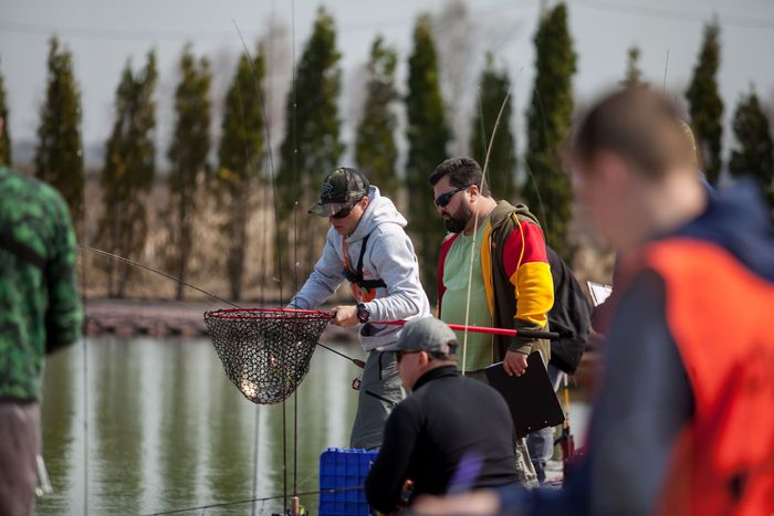 kyiv-ukraine-april-16-2018-fisherman-with-spinning-rod-holds-fish-landing-net.jpg