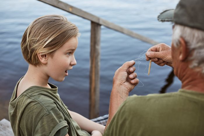 little-boy-fishing-with-his-dad-being-astonished-because-tangled-line-fishing-rod-family-posing-wooden-stairs-leading-water-surprised-male-child.jpg