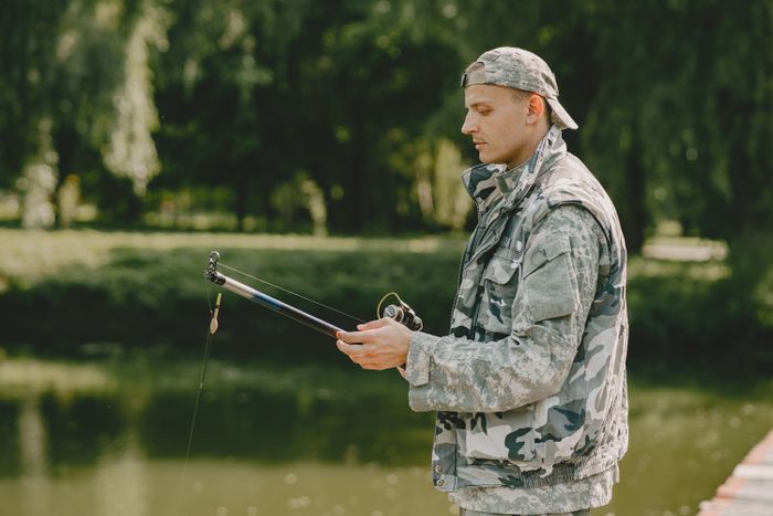 man-fishing-holds-angling-rod (2).jpg