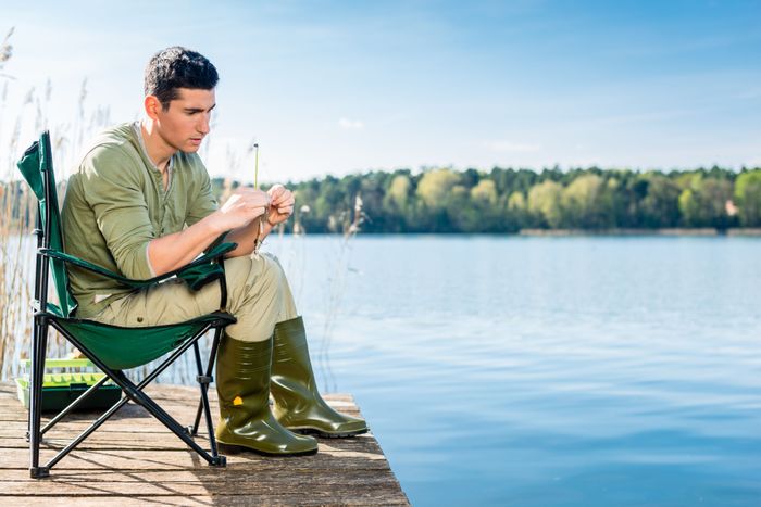 man-fishing-lake-fixing-lure-angling-rod.jpg