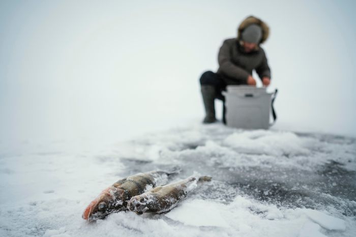 man-getting-ready-fishing-frozen-lake.jpg