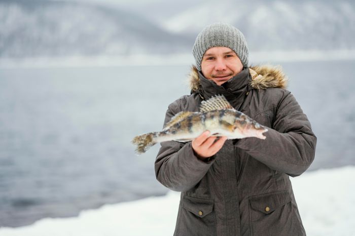 man-holding-victoriously-fish-he-caught.jpg