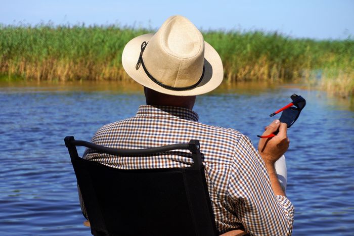 man-relaxing-by-river-enjoying-peaceful-nature.jpg