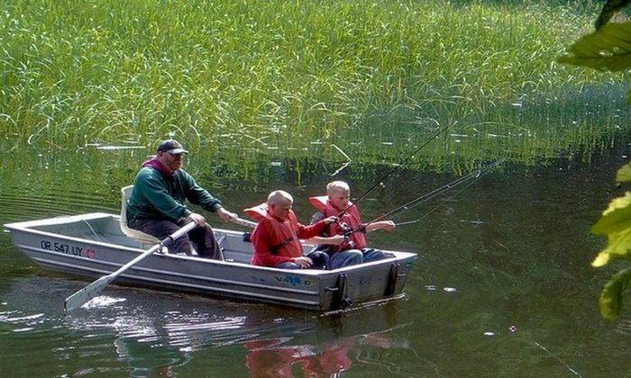 Father and children on the boat fishing 