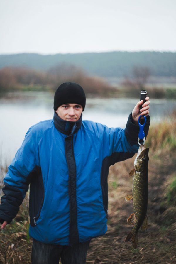 portrait-man-holding-pike-fish-looking-camera.jpg
