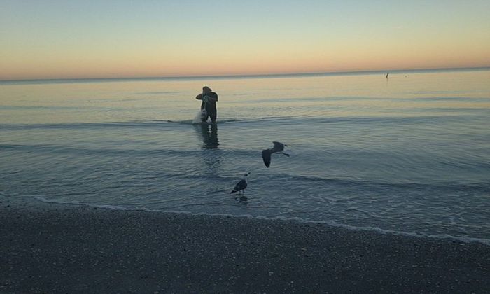 angler fishing at sunrise