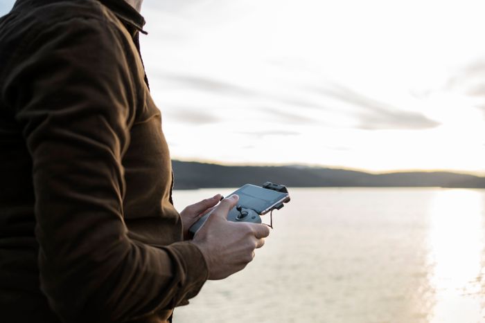 side-view-man-holding-drone-remote.jpg