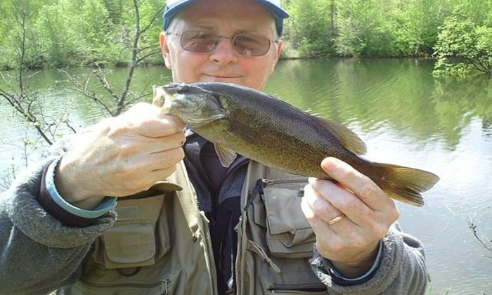 angler holding a smallmouth bass