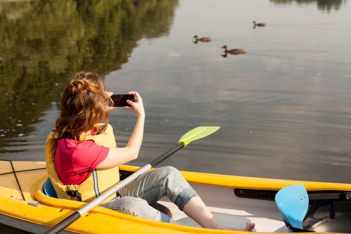 woman-staying-kayak-taking-photos.jpg