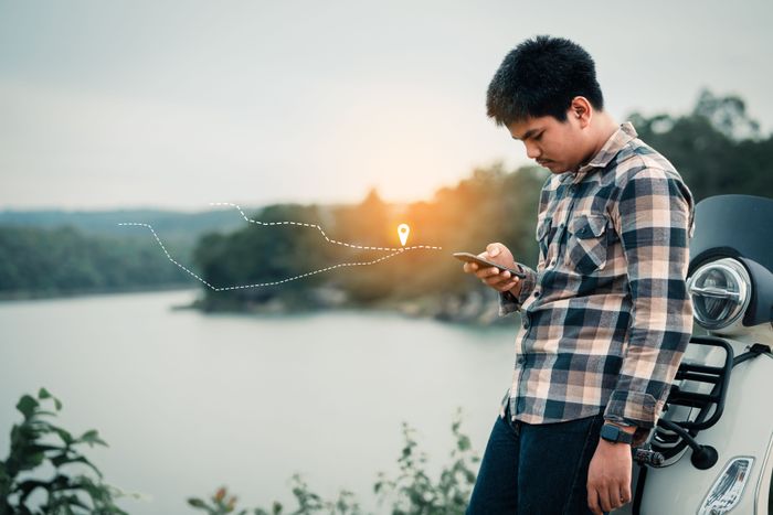young-man-backpack-checking-location-traveling-holiday-selective-soft-focus.jpg