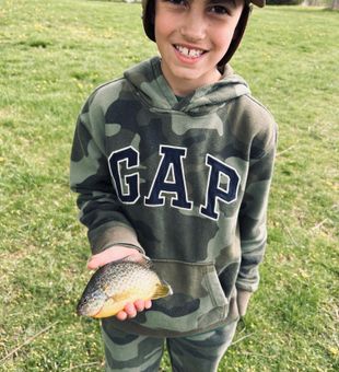 Young man catching first fish