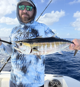 Reeling in a Blackfin Tuna under partly cloudy skies!