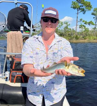 Smiling with a sleek Spanish Mackerel