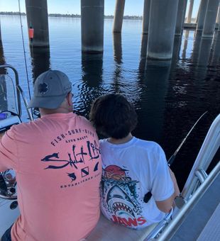 Focused bridge fishing under calm Florida waters