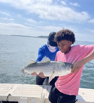 Reeled in a massive striped bass while tackling the deep blue seas around Boston!