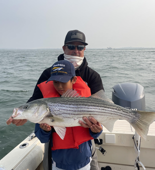 Huge 31-inch Striped Bass reeled in during an epic Deep Sea adventure!