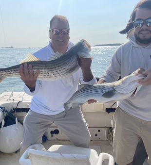 Reeling in two big Striped Bass on a crystal-clear day!