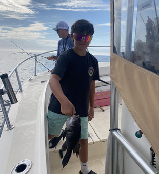 Reeling in a sea bass while the storm clouds gather!