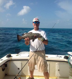 Proud moment with a beautiful grouper catch on the open ocean!