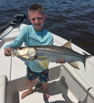 Young angler proudly holds a giant Matlacha Snook!