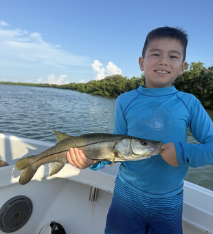 Snook on the line with storm clouds brewing!
