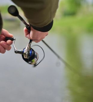 Focused fishing moment — action-packed cast by the water.