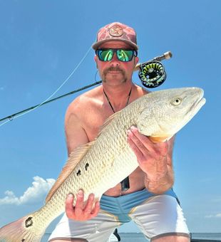 Focused fishing moment — action-packed cast by the water.