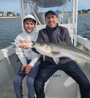 Nice striped bass caught using deep sea jigging techniques in partly cloudy conditions.