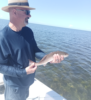 Hooked a feisty redfish at the local boat ramp!
