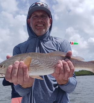 Reeling in reds under stormy skies in Weeki Wachee!