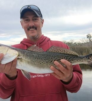 Solid speckled trout catch on an inshore fishing charter