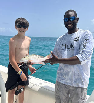 Reeling in a Mutton Snapper on a partly cloudy day in Key Largo!