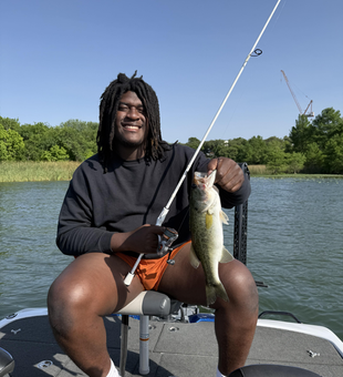 A feisty Florida Bass reeled in against a partly cloudy backdrop with rain clearing later.