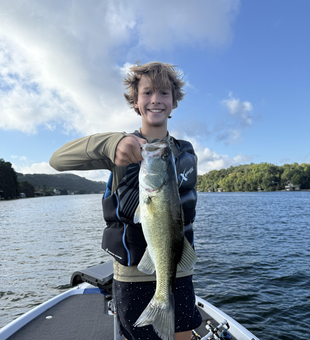 Reeling in a huge Largemouth Bass at Buchanan Dam under clear skies!