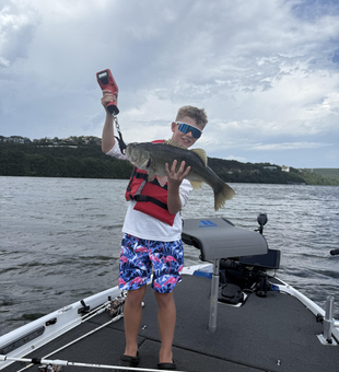 Reeling in a huge Largemouth Bass at Buchanan Dam's partly cloudy paradise!