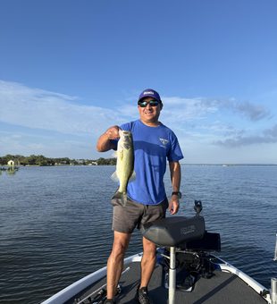 Reeling in a 16-inch Largemouth Bass under partly cloudy skies!